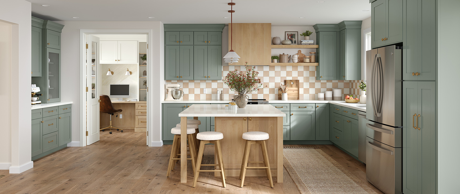 Transitional kitchen with green shaker-style cabinets, light wood island, brass hardware, stainless steel appliances, and checkered tile backsplash.
