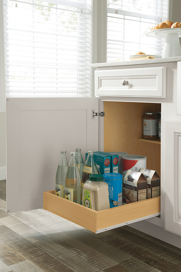 base cabinet roll tray opened and stocked with kitchen supplies